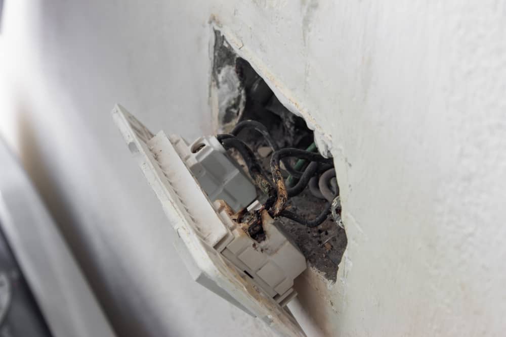 Burned electrical outlet open from wall